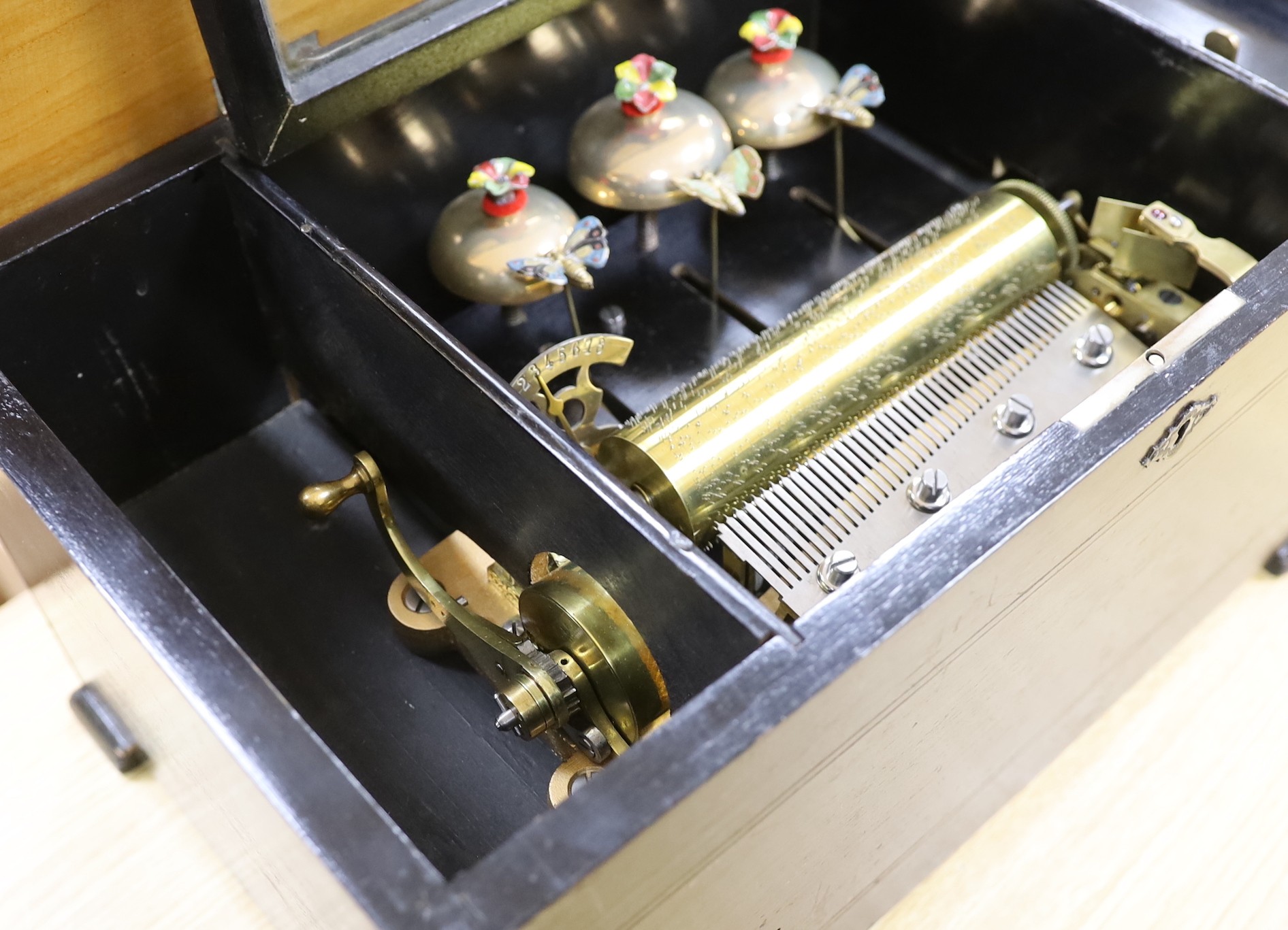 A late 19th century music box, with visible bells movement, 47cms wide, 27cm deep